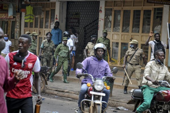 FILE - In this Thursday, Nov. 19, 2020 file photo, Ugandan security forces patrol on a street after protests over the arrest of opposition presidential candidate Bobi Wine, in Kampala, Uganda. The ...