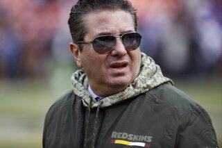 FILE - This Nov. 12, 2017, file photo shows Washington Redskins owner Dan Snyder walking across the field before an NFL football game against the Minnesota Vikings in Landover, Md. Snyder has hired a D.C. law firm to review the Washington NFL team's culture, policies and allegations of workplace misconduct. Beth Wilkinson of Wilkinson Walsh LLP confirmed to The Associated Press that the firm had been retained to conduct an independent review. (AP Photo/Patrick Semansky, File)