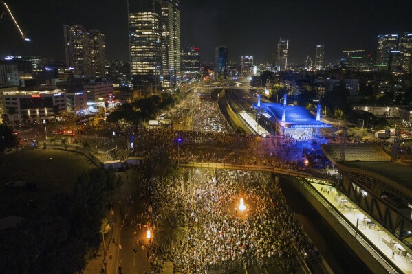 Demonstrators block the traffic on a highway crossing the city during a protest against plans by Netanyahu's government to overhaul the judicial system, in Tel Aviv, Monday, July 24, 2023. Israeli lawmakers on Monday approved a key portion of Prime Minister Benjamin Netanyahu's divisive plan to reshape the country's justice system despite massive protests that have exposed unprecedented fissures in Israeli society. (AP Photo/Oded Balilty)