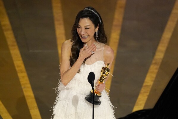 FILE - Michelle Yeoh accepts the award for best performance by an actress in a leading role for "Everything Everywhere All at Once" at the Oscars on March 12, 2023, in Los Angeles. Yeoh has been proposed by the International Olympic Committee to become one of its members. The IOC currently has 99 invited members which include a global selection of royalty, sports officials, former athletes plus leaders from politics and industry. (AP Photo/Chris Pizzello, File)