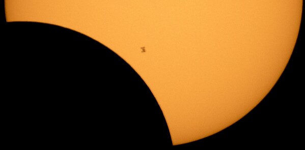 FILE - In this photo provided by NASA, the International Space Station is silhouetted against the sun during a solar eclipse Monday, Aug. 21, 2017, as seen from Ross Lake, Northern Cascades National Park in Washington state. (Bill Ingalls/NASA via AP, File)