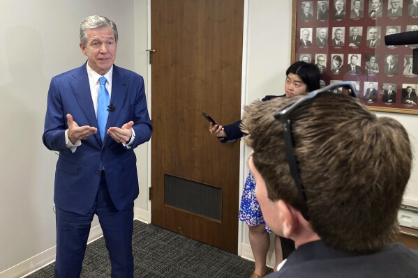 North Carolina Gov. Roy Cooper speaks with reporters after the Council of State meeting at the Department of Transportation headquarters in Raleigh, N.C., Tuesday, Aug. 1, 2023. Cooper said he's not convinced that details within a tax-cut agreement reached between Senate leader Phil Berger and House Speaker Tim Moore will protect the state from revenue shortfalls, (AP Photo/Gary D. Robertson)