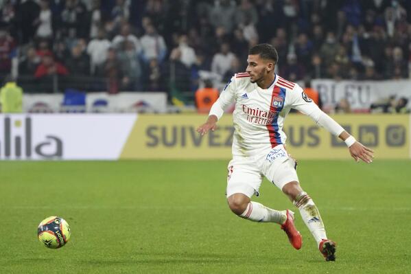 FILE - Lyon's Houssem Aouar controls the ball during the French League One soccer match between Lyon and Monaco at the Groupama stadium in Lyon, France, Saturday, Oct. 16, 2021. French soccer club Lyon has condemned the online racist abuse suffered by midfielder Houssem Aouar after he chose to represent Algeria despite previously playing for France's national team. Aouar, who was jeered by some of his home fans during a league game against Nantes last Friday, posted a screenshot on Instagram on Wednesday, March 22, 2023 showing some of the racist abuse he has been receiving. (AP Photo/Laurent Cipriani, File)