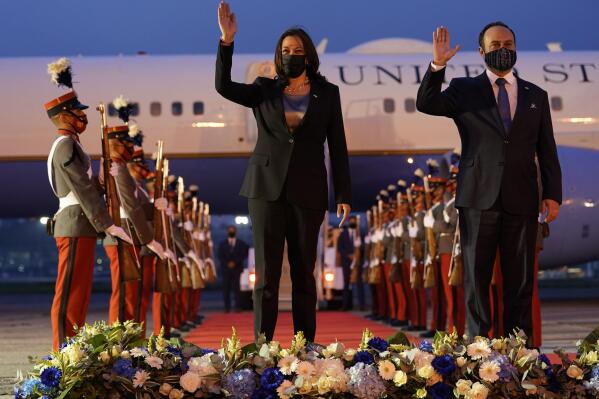 FILE - Vice President Kamala Harris and Guatemala's Minister of Foreign Affairs Pedro Brolo wave at her arrival ceremony in Guatemala City, Sunday, June 6, 2021, at the Guatemalan Air Force Central Command. According to Lindsey Zuluaga, an aid to United States Vice President Kamala Harris, the Japanese Yazaki Corporation started on Wednesday, February 15, 2023, production of auto parts in Guatemala, a result of Harris´ promise to help create jobs in the Central American nation and keep Guatemalans from emigrating to the U.S. (AP Photo/Jacquelyn Martin, File)