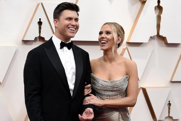 FILE  - Colin Jost, left, and Scarlett Johansson arrive at the Oscars in Los Angeles on Feb. 9, 2020. The married couple, who once made comedy skits on “Saturday Night Live," are reuniting onscreen for a new Super Bowl commercial. The 60-second ad launches Monday, Feb. 7, 2022, and will be televised during Super Bowl 56 on Feb. 13.  (Photo by Jordan Strauss/Invision/AP, File)