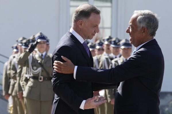 Poland's President Andrzej Duda, left, greets Portuguese President Marcelo Rebelo de Sousa during a state visit at the Belvedere Palace in Warsaw, Poland, Tuesday, Aug. 22, 2023. At a joint news conference de Sousa vowed continuing support for Ukraine's struggle against Russia's invasion, while Duda said Poland is watching Russia's transfer of some nuclear weapons into neighbouring Belarus. (AP Photo/Czarek Sokolowski)