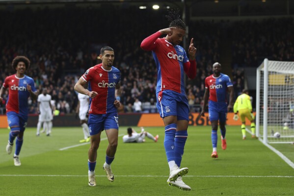Crystal Palace's Michael Olise celebrates scoring their first goal of the game during the English Premier League soccer match between West Ham United and Crystal Palace at Selhurst Park in London, Sunday April 21, 2024. (Steven Paston/PA via AP)
