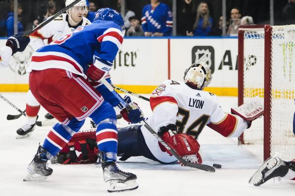 New York Rangers' Jimmy Vesey, front left, shoots the puck past Florida Panthers goaltender Alex Lyon (34) for a goal during the second period of an NHL hockey game Monday, Jan. 23, 2023, in New York. (AP Photo/Frank Franklin II)