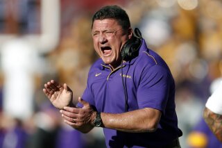 FILE - In this Saturday, Nov. 9, 2019 file photo, LSU head coach Ed Orgeron reacts after a LSU touchdown in the first half of an NCAA football game against Alabama in Tuscaloosa, Ala. This is the rare SEC team whose schedule might have gotten a tad easier by playing a conference-only slate. The SEC opponents added to LSU’s schedule last month were Missouri (6-6 last season) and Vanderbilt (3-9). LSU had to drop a scheduled home date with No. 14 Texas, though its other non-conference games would have been lackluster matchups with Rice, Nicholls and Texas-San Antonio. (AP Photo/John Bazemore, File)
