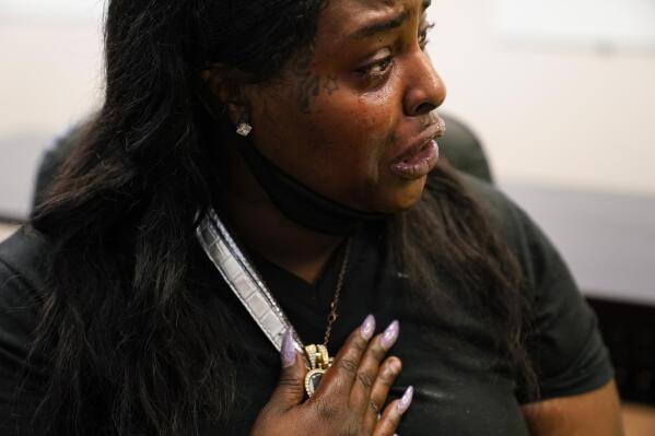 Natisha Stansberry cries as she holds a locket of her child close to her chest in St. Louis on Monday, May 17, 2021. Stanberry was a victim of childhood sexual assault and her brother was murdered. She was told during a drug test that rat poison and fentanyl were found in her urine test when she went to Assisted Recovery Centers of America for help with her drug addiction. (AP Photo/Brynn Anderson)