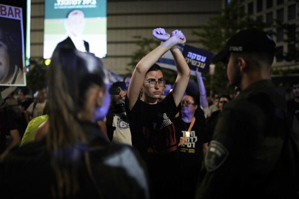 Demonstrators block a road during a protest against Israeli Prime Minister Benjamin Netanyahu's government and calling for the release of hostages held in the Gaza Strip by the Hamas militant group, in Tel Aviv, Israel, Saturday, May 18, 2024. (AP Photo/Leo Correa)
