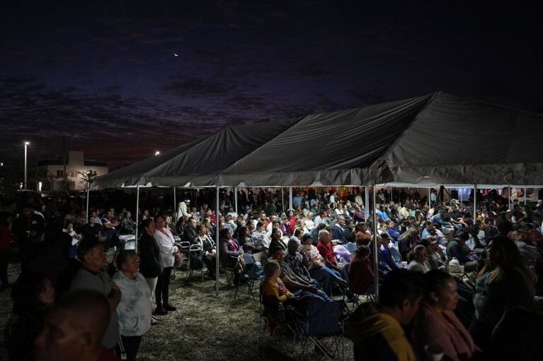 Devotees gather before dawn for a festival celebrating the Virgin of Guadalupe, one of several apparitions of the Virgin Mary witnessed by an indigenous Mexican man named Juan Diego in 1531, at St. Ann Mission in Naranja, Fla., Sunday, Dec. 10, 2023. For this mission church where Miami's urban sprawl fades into farmland and the Everglades swampy wilderness, it's the most important event of the year, both culturally and to fundraise to continue to minister to the migrant farmworkers it was founded to serve in 1961. (AP Photo/Rebecca Blackwell)