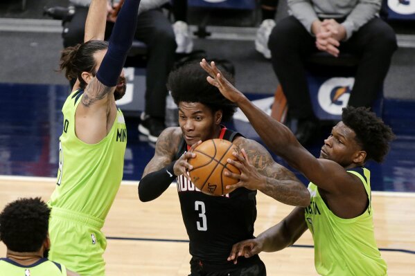 Houston Rockets guard Kevin Porter Jr. (3) drives on Minnesota Timberwolves forward Anthony Edwards, right and guard Ricky Rubio during the first quarter of an NBA basketball game Saturday, March 2...
