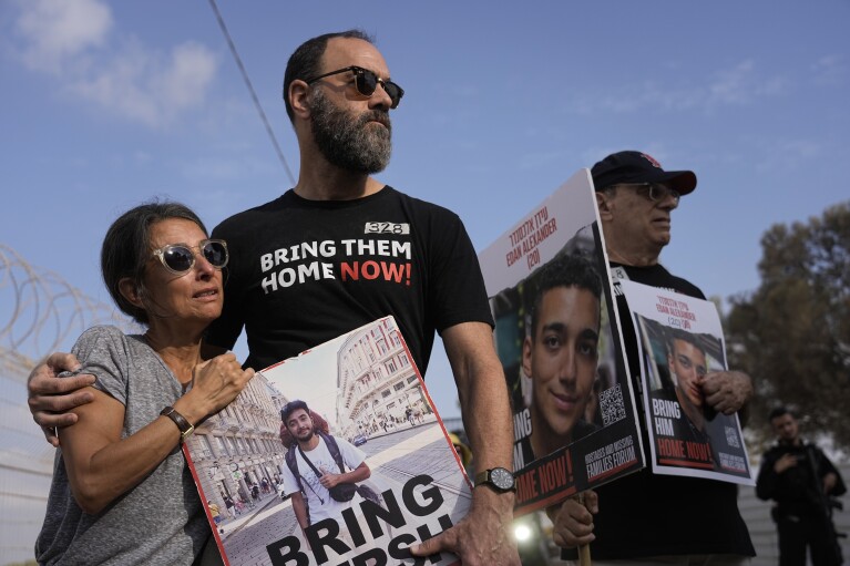 Rachel Goldberg, left, and Jon Polin center, parents of Israeli-American hostage Hersh Polin-Goldberg, along with other relatives of hostages held in the Gaza Strip by the Hamas militant group take part in a protest calling for their release in the Kibbutz Nirim, southern Israel, Thursday, Aug. 29, 2024. (AP Photo/Tsafrir Abayov)