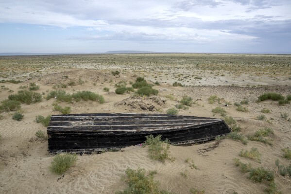 A worn-out boat sits near the dried-up Aral Sea, near Aralsk, Kazakhstan, Saturday, July 1, 2023. (AP Photo/Ebrahim Noroozi)