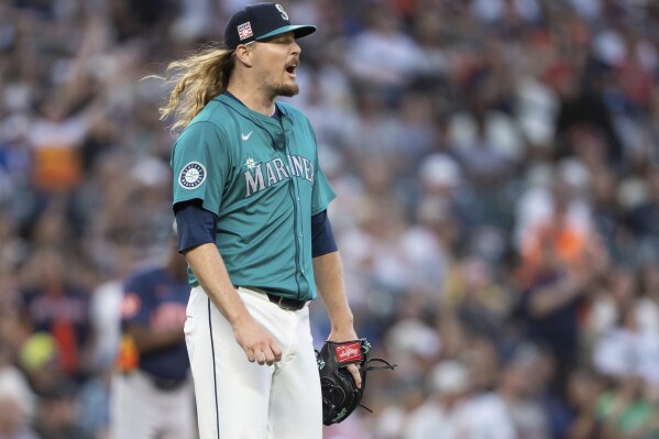 Seattle Mariners relief pitcher Ryne Stanek reacts after giving up a two-run home run during the seventh inning of a baseball game against the Houston Astros, Saturday, July 20, 2024, in Seattle. (ĢӰԺ Photo/Stephen Brashear)