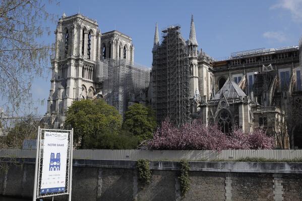 FILE - In this file photo dated Thursday, April 15, 2021, Notre Dame cathedral shrouded in scaffolding in Paris. After more than two-years of work to stabilize and protect it after the shocking fire that tore through its roof and knocked down its spire, France’s Notre Dame Cathedral is finally stable and secure enough for artisans to start rebuilding it, according to a government statement Saturday Sept. 18, 2021.  (AP Photo/Francois Mori, FILE)