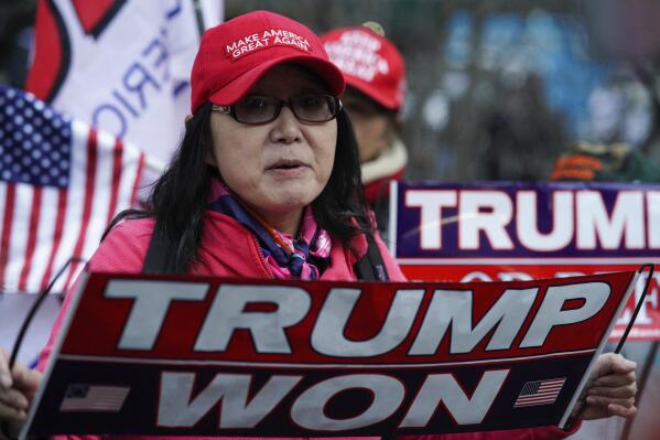 Stephanie Lu, of New York, stands in front of the New York Criminal Courts building criticizing New York County District Attorney Alvin Bragg and a possible criminal indictment of former President Donald Trump, on Monday, March 20, 2023, in New York. (AP Photo/Eduardo Munoz Alvarez)