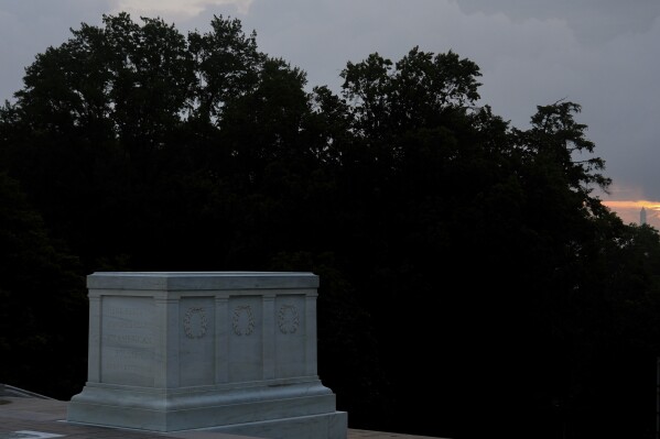 The Washington Monument is visible behind the Tomb of the Unknown Soldier at sunrise, Thursday, May 15, 2025, Arlington National Cemetery in Arlington, Va. (AP Photo/Julia Demaree Nikhinson)