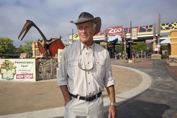 FILE—In this Sept. 5, 2013, file photo, Jack Hanna stands at the front entrance of the Columbus Zoo and Aquarium in Powell, Ohio. It's been a challenging year that began on Jan. 1, 2021, the first day of famed zookeeper Hanna's retirement — after 42 years as the beloved celebrity director-turned-ambassador of the nation’s second-largest zoo. But the Association of Zoos and Aquariums' president predicts incoming CEO Tom Schmid can bring the zoo “roaring back.” (Tom Dodge/The Columbus Dispatch via AP, File)