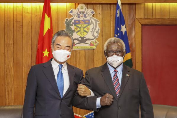 FILE -  In this photo released by Xinhua News Agency, Solomon Islands Prime Minister Manasseh Sogavare, right, locks arms with visiting Chinese Foreign Minister Wang Yi in Honiara, Solomon Islands on May 26, 2022. A U.S. coast guard cutter conducting patrols as part of an international mission to prevent illegal fishing was recently unable to get clearance for a scheduled port call in the Solomon Islands, according to reports, an incident that comes amid growing concerns of Chinese influence on the Pacific nation. (Xinhua via AP, File)
