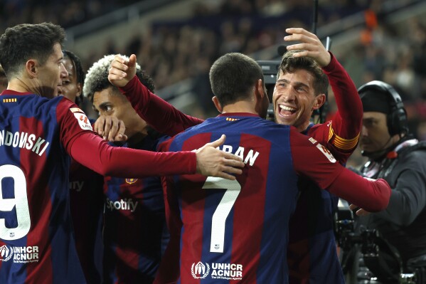 Barcelona's Sergi Roberto, right, celebrates with teammates after scoring his side's second goal during the Spanish La Liga soccer match between Barcelona and Almeria at the Olimpic Lluis Companys stadium in Barcelona, Spain, Wednesday, Dec. 20, 2023. (AP Photo/Joan Monfort)