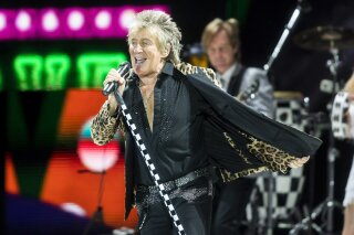 FILE - In this Jan. 29, 2018, file photo, British rock singer Rod Stewart performs during his concert in Papp Laszlo Sports Arena in Budapest, Hungary. Rock star Rod Stewart and his son Sean are facing simple battery charges after an altercation with a security guard at The Breakers hotel in Palm Beach, Fla., on New Year's Eve. (Balazs Mohai/MTI via AP, File)