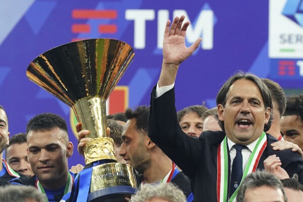 Inter coach Simone Inzaghi and Inter football players celebrate winning the "scudetto" after the Serie A soccer match between Inter and Lazio at the San Siro Stadium in Milan, Italy, Sunday, May 19, 2024. (Spada/LaPresse via AP)