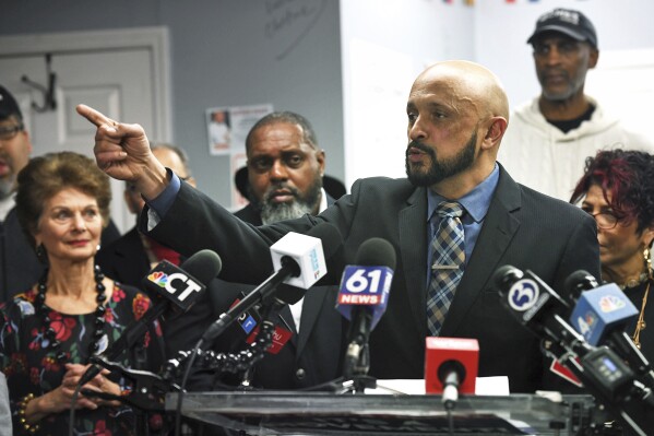 John Gomes speaks during a news conference at his campaign headquarters, Wednesday, Jan. 31, 2024, in Bridgeport, Conn. Gomes announced Wednesday that he's staying in the mayoral race, despite losing a do-over Democratic primary ordered by a judge who threw out the results of the last one because of allegations of absentee ballot stuffing. Gomes is eligible to appear on the ballot for the special Feb. 27 general election as the Independent Party candidate. (Ned Gerard/Hearst Connecticut Media via AP)