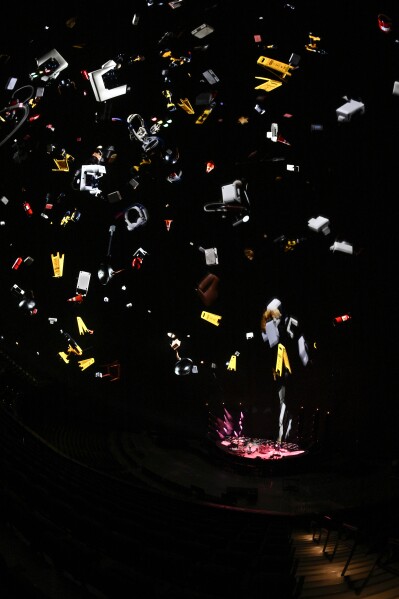During "Life Saving Gun," visuals from throughout the band's history fell from the top of the screen. This photo was taken from rehearsals on Tuesday.  (AP Photo/David Becker)