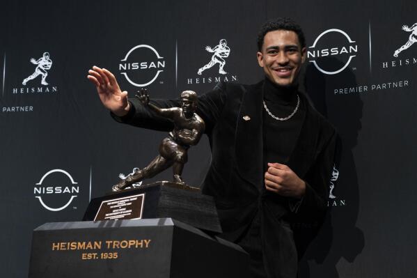Alabama quarterback Bryce Young poses for a photograph after winning the Heisman Trophy, Saturday, Dec. 11, 2021, in New York. (AP Photo/John Minchillo)