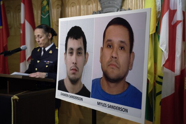 FILE - Assistant Commissioner Rhonda Blackmore speaks next to images of Damien Sanderson and Myles Sanderson during a news conference at the Royal Canadian Mounted Police 