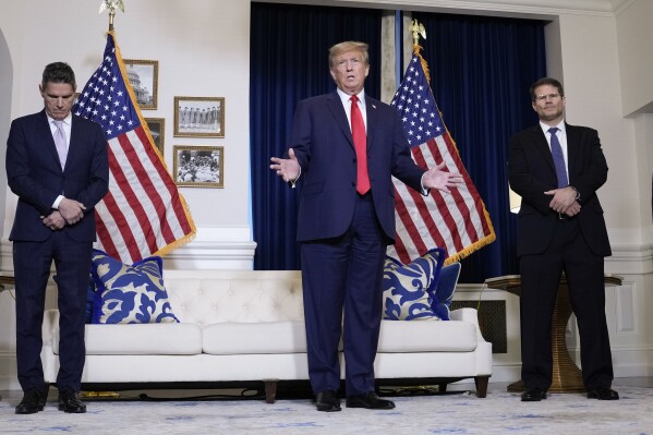 Former President Donald Trump speaks to the media at a Washington hotel, Tuesday, Jan. 9, 2024, after attending a hearing before the D.C. Circuit Court of Appeals at the federal courthouse in Washington, with attorneys John Lauro, left, and D. John Sauer, right. (AP Photo/Susan Walsh) (AP Photo/Susan Walsh)