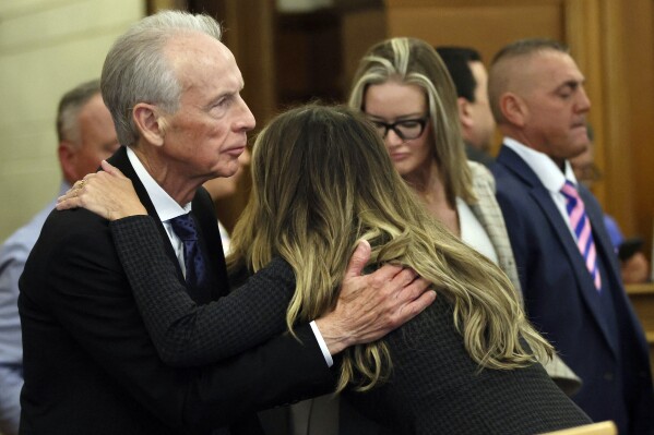 Defendant Karen Read embraces her father following proceedings in her murder trial, Tuesday, April 30, 2024, in Dedham, Mass. Read, 44, of Mansfield, faces several charges including second degree murder in the death of her Boston Police officer boyfriend John O’Keefe, 46, in 2022. (Nancy Lane/The Boston Herald via AP, Pool)