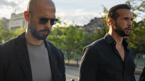 FILE - Andrew Tate, left, and his brother Tristan leave the Court of Appeal in Bucharest, Romania, July 6, 2023. On Tuesday, July 11, the controversial social media personality and his brother filed a Florida lawsuit against the woman whose allegations they say led to their arrest in Romania on human trafficking charges, accusing her of lying when she says they imprisoned her there. (AP Photo/Andreea Alexandru, File)