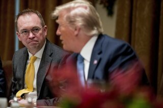 FILE - In this Thursday, Dec. 5, 2019, file photo, then-acting chief of staff Mick Mulvaney, left, listens to President Donald Trump, right, speak at a luncheon with members of the United Nations Security Council in the Cabinet Room at the White House in Washington. Republicans are coming to grips with the fallout of Trump's false attacks on the election, which fueled the anger of supporters who stormed the U.S. Capitol on Jan. 6, 2021. Mulvaney says he never thought people would take the president's words so literally. (AP Photo/Andrew Harnik, File)
