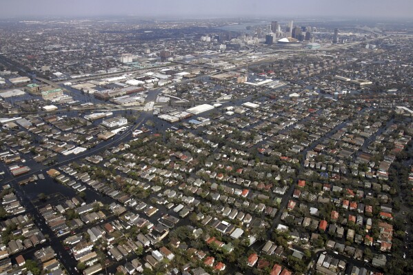 FILE - Portions of New Orleans remain covered in floodwaters from Hurricane Katrina, Sept. 9, 2005. With a housing crisis that has priced out many Native Hawaiians as well as families that have been there for decades, concerns are rising that Maui could become the latest example of “climate gentrification,” when it becomes harder for local people to afford housing in safer areas after a climate-amped disaster. Other examples include New Orleans after Hurricane Katrina in 2005 and Paradise, Calif., after the 2018 Camp Fire. (AP Photo/David J. Phillip, Pool, File)