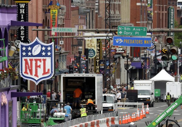 
              A temporary NFL neon sign joins the permanent ones along Broadway as preparation continues for the NFL Draft Tuesday, April 23, 2019, in Nashville, Tenn. The NFL Draft is scheduled to be held Thursday through Saturday. (AP Photo/Mark Humphrey)
            