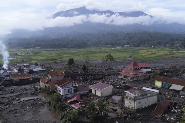 This drone photo shows the damage at a village affected by a flash flood in Agam, West Sumatra, Indonesia, Tuesday, May 14, 2024. Rescuers on Tuesday searched in rivers and the rubble of devastated villages for bodies, and whenever possible, survivors of flash floods that hit Indonesia's Sumatra Island over the weekend. (AP Photo/Sutan Malik Kayo)