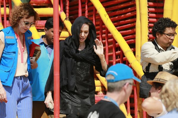 
              Hollywood actress Angelina Jolie returns after visiting a school at Kutupalong refugee camp in Cox's Bazar, Bangladesh, Tuesday, Feb. 5, 2019. Nearly 700,000 Rohingya, a persecuted Muslim minority in Myanmar, are living in refugee camps in coastal Cox's Bazar after fleeing their villages following a military crackdown. (AP Photo)
            