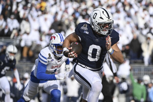 Penn State linebacker Dominic DeLuca returns an interception for a touchdown while being chased by SMU running back Brashard Smith during the first half in the first round of the NCAA College Football Playoff, Saturday, Dec. 21, 2024, in State College, Pa. (AP Photo/Barry Reeger)