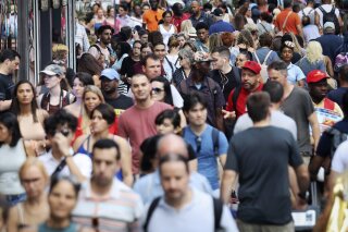 FILE - In this Aug. 22, 2019, file photo, people walk through New York's Times Square. The population of non-Hispanic whites in the U.S. has gotten smaller in the past decade as deaths have surpassed births in this aging demographic, and a majority of the population under age 16 is nonwhite for the first time though they are fewer in number than a decade ago, according to new figures released Thursday, June 25, 2020,  by the U.S. Census Bureau. (AP Photo/Bebeto Matthews, File)
