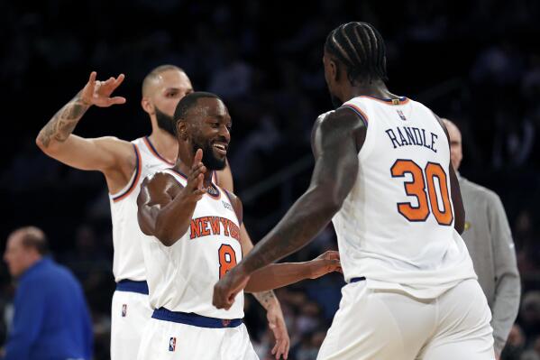 New York Knicks guard Kemba Walker (8) celebrates with forward Julius Randle (30) against the Indiana Pacers during the first half of a preseason NBA basketball game Tuesday, Oct. 5, 2021, in New York. The Knicks won 125-104. (AP Photo/Adam Hunger)