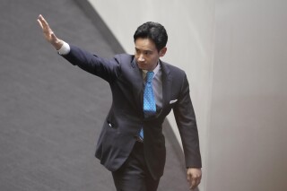 FILE - Pita Limjaroenrat, the leader of the Move Forward Party wave and leaves from a meeting room at Parliament in Bangkok, Thailand, on July 19, 2023. The embattled head of the Move Forward party, which finished first in Thailand’s general election in May but was denied power by Parliament, announced his resignation on Friday, Sept. 15, 2023 as its chief so the party can appoint a new member to serve as Parliament's opposition leader. (AP Photo/Sakchai Lalit, File)