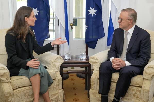 The Prime Minister of Finland Sanna Marin gestures as she talks with Australian Prime Minister Anthony Albanese at Kirribilli House in Sydney, Australia, Friday, Dec. 2, 2022. (AP Photo/Mark Baker)