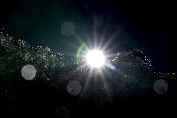FILE - The sun shines behind the Jamtalferner Glacier near Galtuer, Austria, Sept. 6, 2023. The world is in danger of hitting the point of no return for five of Earth’s natural systems because of human-caused climate change, a team of scientists said on Wednesday, Dec. 6, on the sidelines of the United Nations’ climate summit. (AP Photo/Matthias Schrader, File)