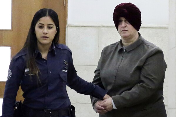 FILE - Israeli-born Australian Malka Leifer, right, is brought to a courtroom in Jerusalem on Feb. 27, 2018. Leifer, a former principal of an Australian Jewish school, was sentenced on Thursday, Aug. 24, 2023, to 15 years in prison after she was convicted of sexually abusing two students. (AP Photo/Mahmoud Illean, File)