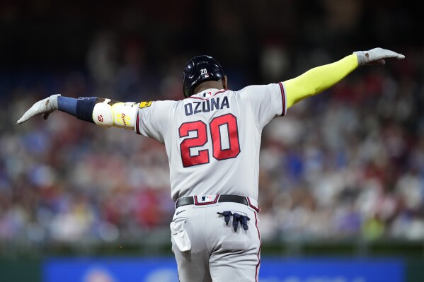 Atlanta Braves' Marcell Ozuna reacts after hitting a three-run home run against Philadelphia Phillies pitcher Zack Wheeler during the fifth inning of a baseball game, Tuesday, Sept. 12, 2023, in Philadelphia. (AP Photo/Matt Slocum)