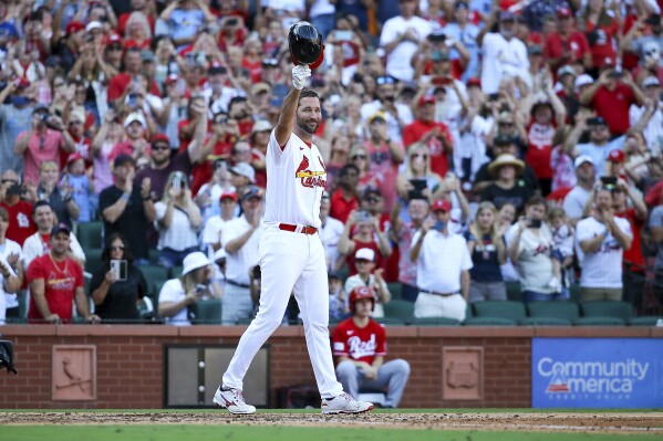 St. Louis Cardinals' Adam Wainwright raises his batting helmet to fans as he prepares to pinch hit during the eighth inning of a baseball game against the Cincinnati Reds, Sunday, Oct. 1, 2023, in St. Louis. (AP Photo/Scott Kane)