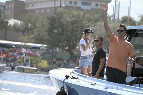 Tampa Bay Buccaneers NFL football quarterback Tom Brady waves to fans as he celebrates their Super Bowl 55 victory over the Kansas City Chiefs with a boat parade in Tampa, Fla., Wednesday, Feb. 10, 2021. (AP Photo/Phelan Ebenhack)